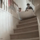 Girl falls during matress slide on the stairs