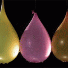 Bullets hit balloons in slow-motion