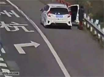 1421869418_woman_resting_on_road_shoulder_gets_hit_by_runaway_tire.gif