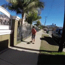Woman gives son a hand while skateboarding