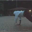 Break dancer owned by kid on bicycle