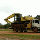 Excavator getting off truck