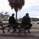 Freerunner jumps over cop