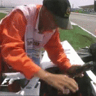 F1 wheel goes over guy's legs