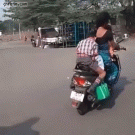 Kid does homework while riding backseat of bike