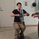 Angular momentum demonstrated with bycicle wheen and spinning chair