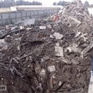 Construction worker lights cigarette with excavator
