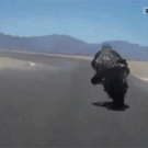 Biker touches ground with head during turn