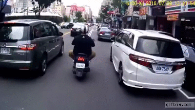 man-opens-car-door-on-scooter-rider.gif