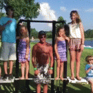 Grandpa lifts grandchildren