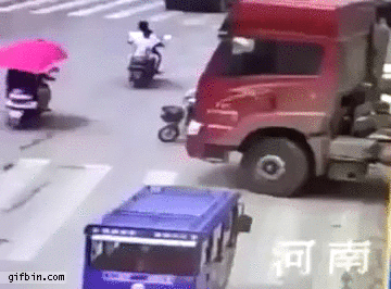 woman-on-bicycle-survives-after-being-run-over-by-truck.gif