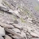 Boulder coming down hill almost hits man