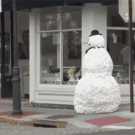 Little girl scared of snowman falls down