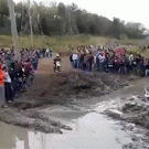 Guy on the phone jumps over crashing dirt bike