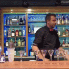 Bartender juggles bottle on forearm