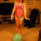 Girl jumps on ball