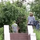 Skater comes down long stair ledge