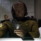 Worf drinking and laughing