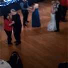 Kid dances on the floor at wedding