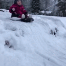 Kid enjoying snow sled ride