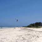 Kite surfer jumps over island