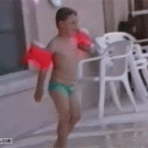 Kid with arm floaties swimming pool jump fail