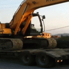 Excavator pushes truck