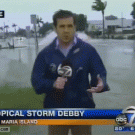 Reporter gets splashed by passing truck