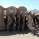 Soldiers enter a porta-potty