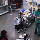 Veterinarian slaps himself in the face with rubber glove