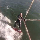 Kite surfer jumps over whale