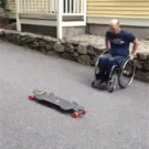 Guy in wheelchair rides a longboard