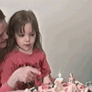 Kid blows girl's candles