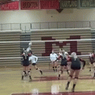 Girl does a split while playing volleyball