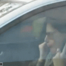Girl in car picks nose