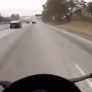 Lucky biker misses flying matress on highway