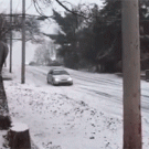Car makes left turn on snowy road